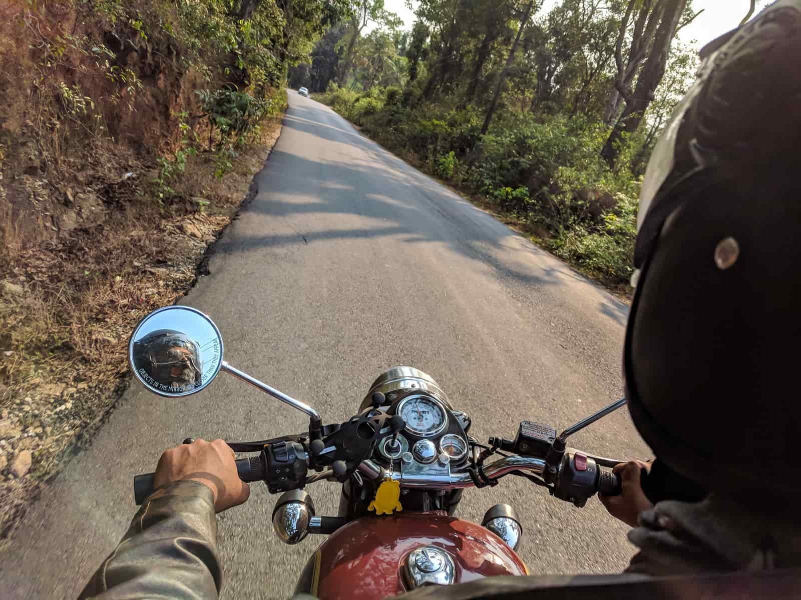A motorcyclist riding an open highway at dusk